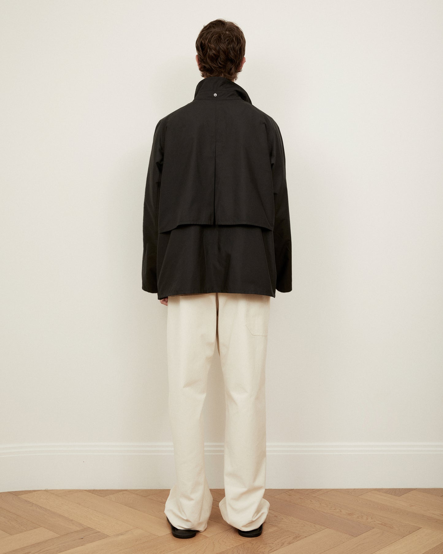 Morrow fashion black dry jacket back view with storm flap and hood detached 