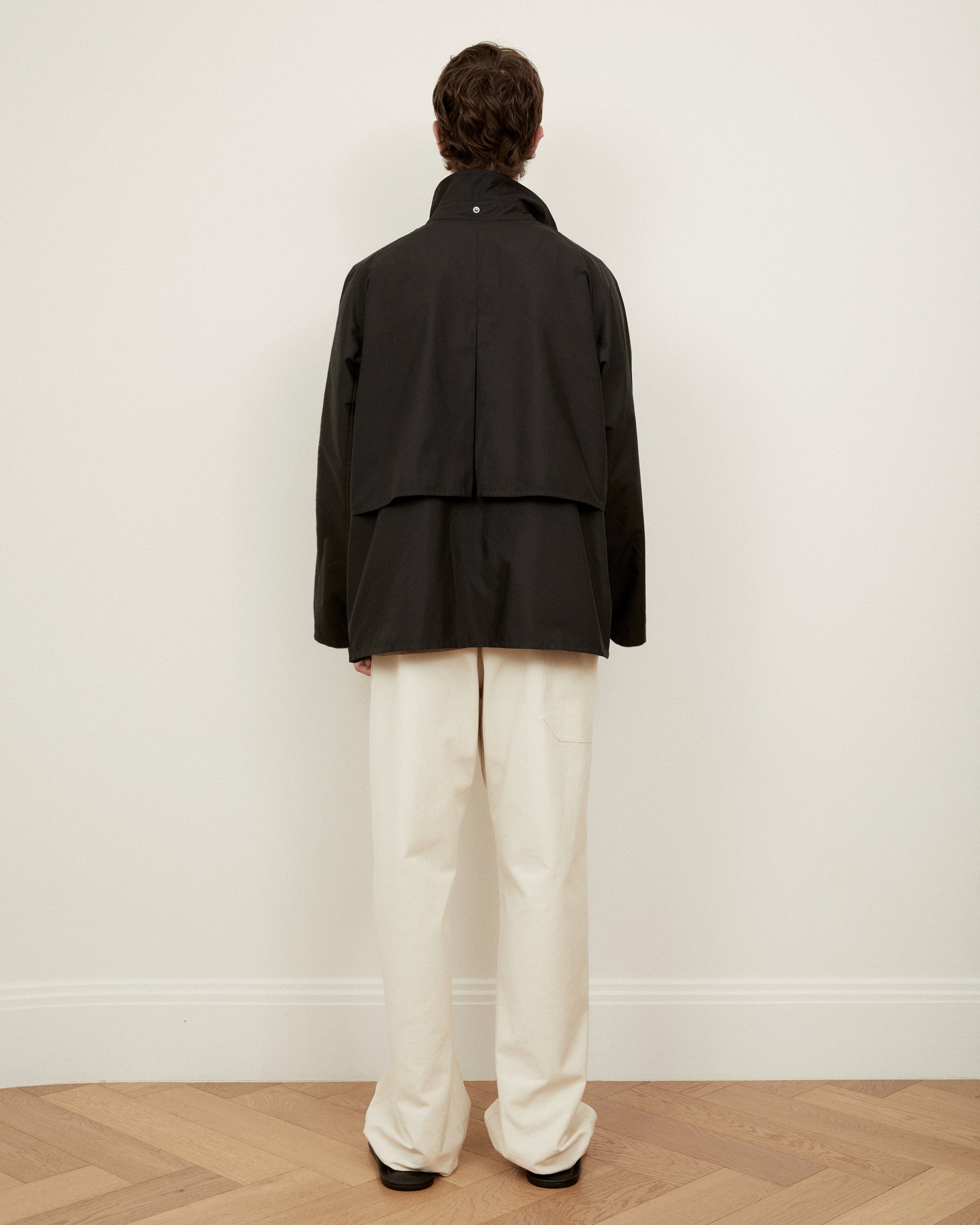 Morrow fashion black dry jacket back view with storm flap and hood detached 