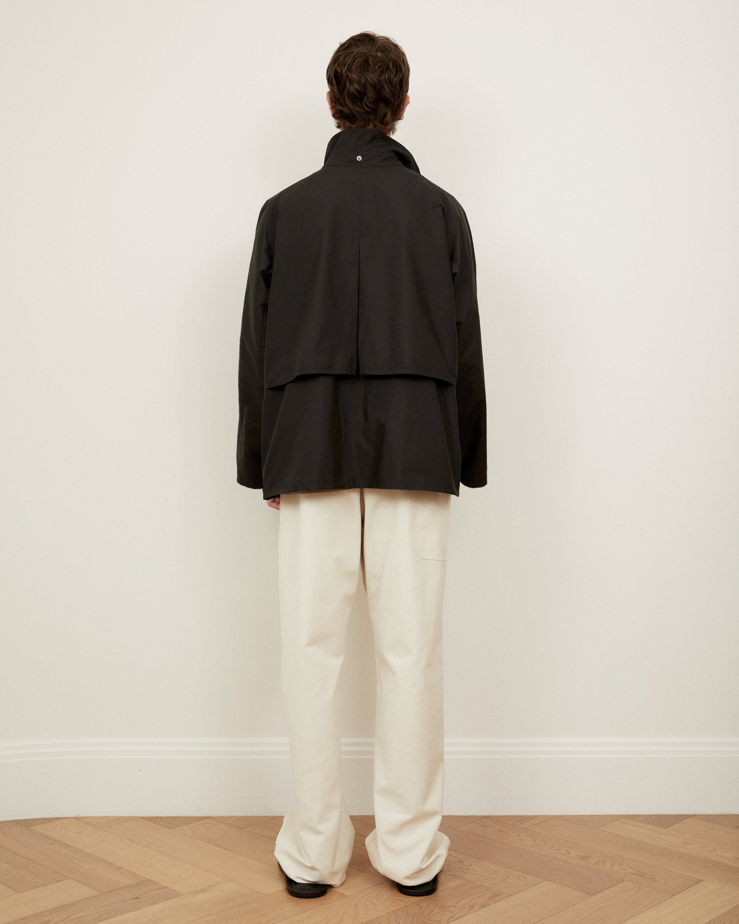 Morrow fashion black dry jacket back view with storm flap and hood detached 